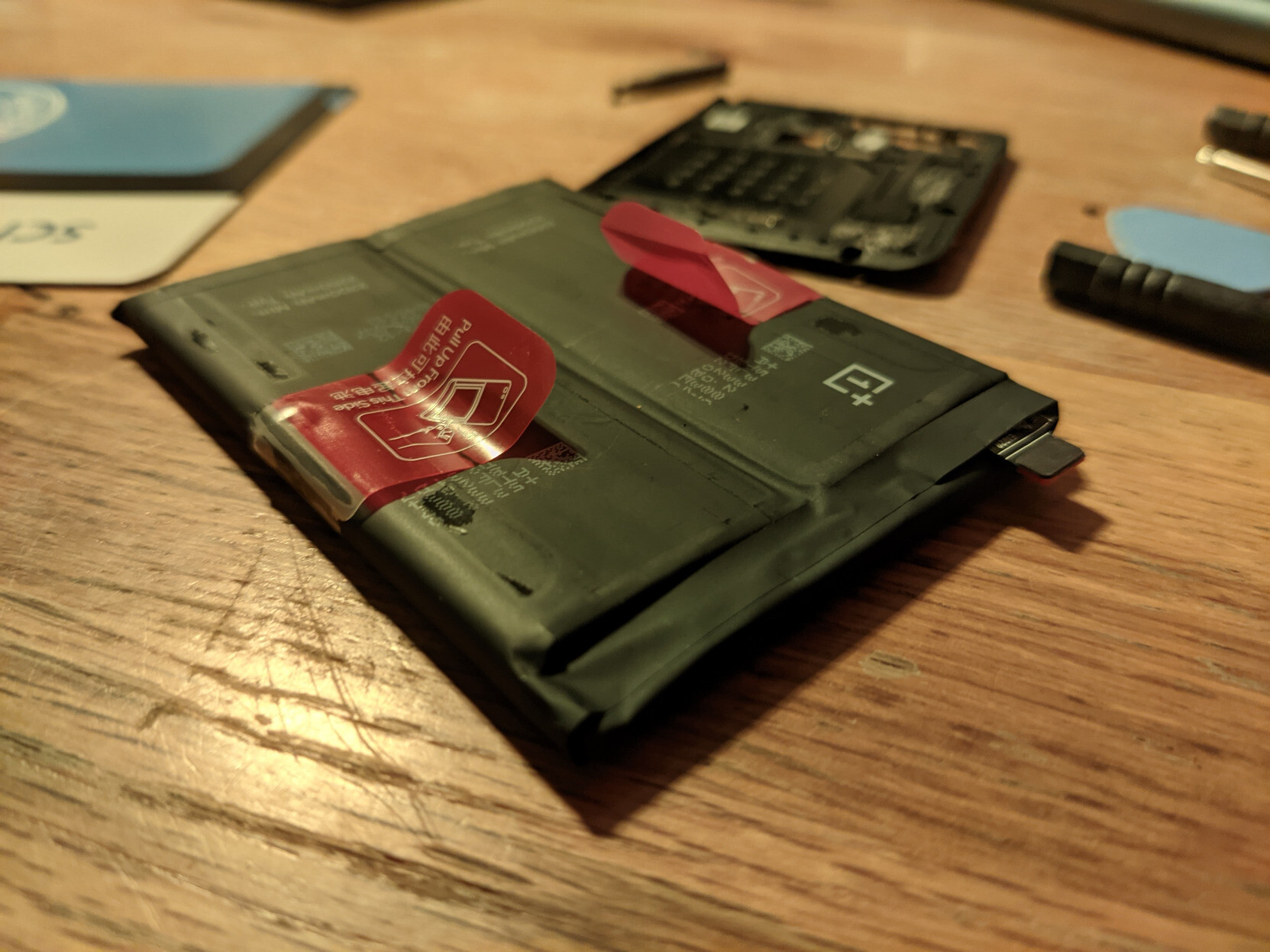 An old OnePlus battery from my phone. The sides are lifted up since I had to pry it from the case.