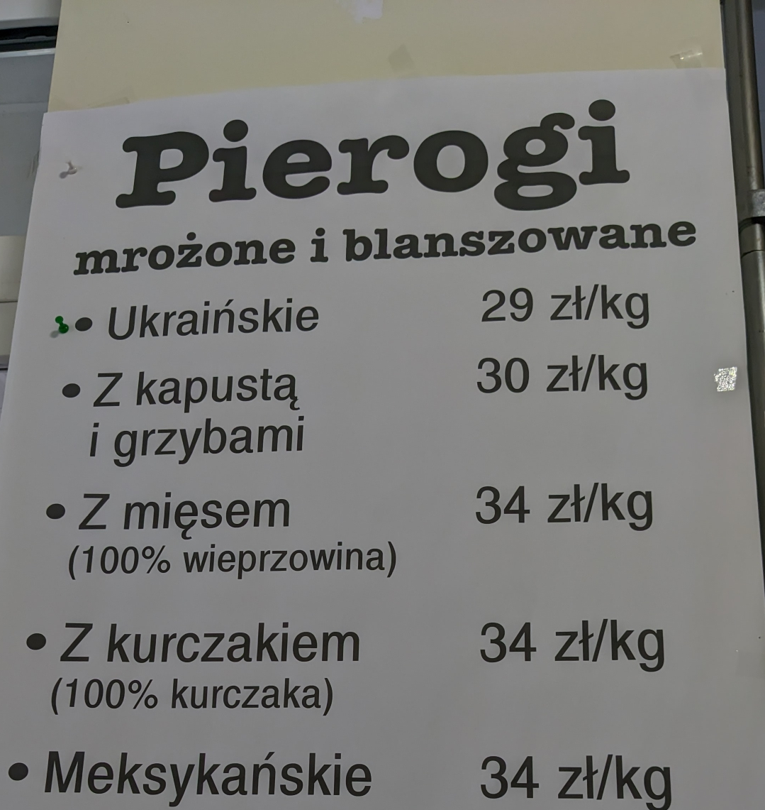 a Pierogi sign in bold black letters. mrożone i blanszowane. The first pierogi offered, is pierogi 